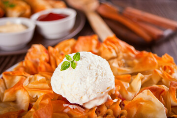 Fresh homemade cherry filo dough pie tart with vanilla ice cream. Close up.
