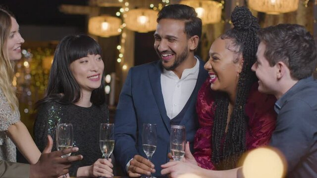 Sliding Shot of Group of Friends During New Years Celebrations In a Bar