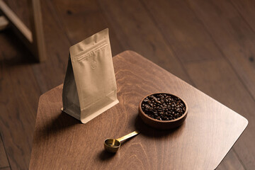 Blank coffee packaging on a wooden table, with pot, coffee seeds bowl, on a wooden background,...