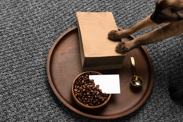 Blank coffee packaging on a wooden tray, with a business card, coffee seeds bowl, copper spoon,...