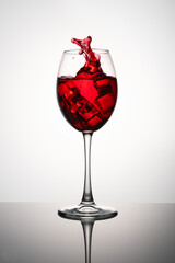 a glass of red wine on a white background