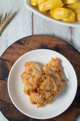 Jack fruit fritter, traditional yet delicious snacks for tea or coffee time and it's also good brunch. High view with rustic white background