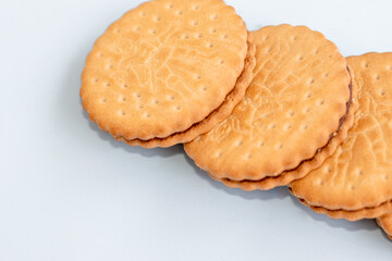 cookies round shape from two parts with chocolate in the middle in a row or one over another in tower.one bitten biscuit.carbs sweets sugar unhealthy food,kids favorites.isolated free space text
