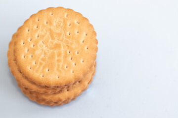 cookies round shape from two parts with chocolate in the middle in a row or one over another in tower.one bitten biscuit.carbs sweets sugar unhealthy food,kids favorites.isolated free space text