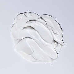 Sample of white cosmetic cream, drops of gel and foam on a gray background.
