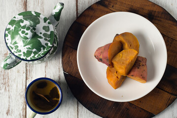 Steamed sweet potato, healthy snack for tea or coffee time and also brunch. Picture in top view or flatlay on wooden board and white background