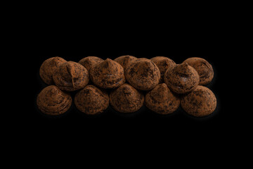 Chocolate truffles on a black background.