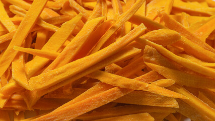 Dry tasty mango slices as a background.