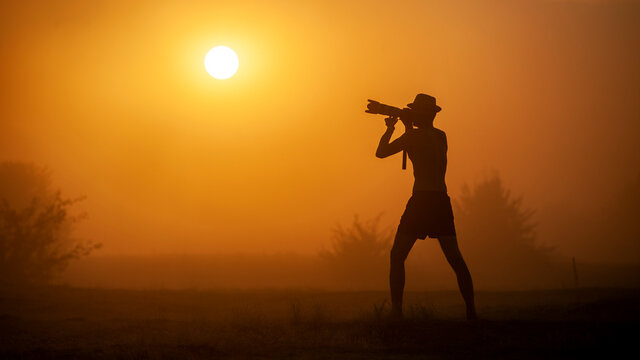 
National geography photographer in the desert with a sandstorm takes pictures of interesting shots