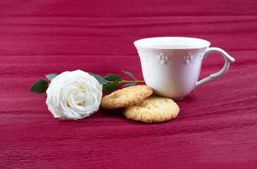 Obraz na płótnie Canvas Tea with cookies and flower on red background