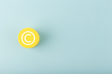 Minimal trendy copyright, intellectual property and patenting concept. Copyright symbol on yellow...