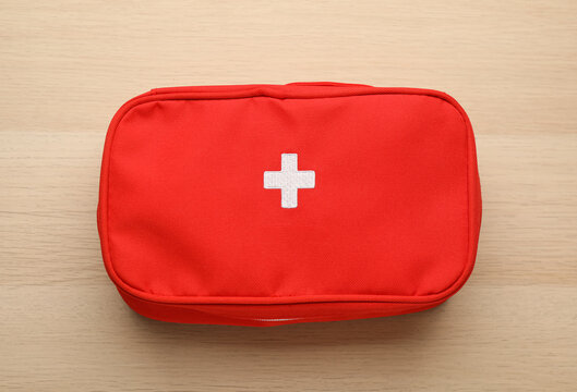 First Aid Kit Bag On Wooden Table, Top View. Health Care