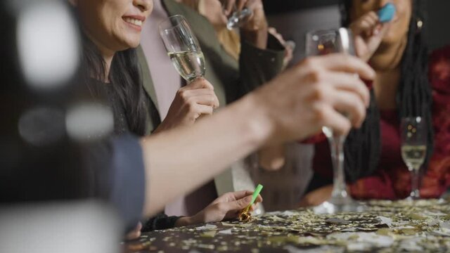 Medium Shot of Friends Drinking Champagne During New Years Eve Celebrations