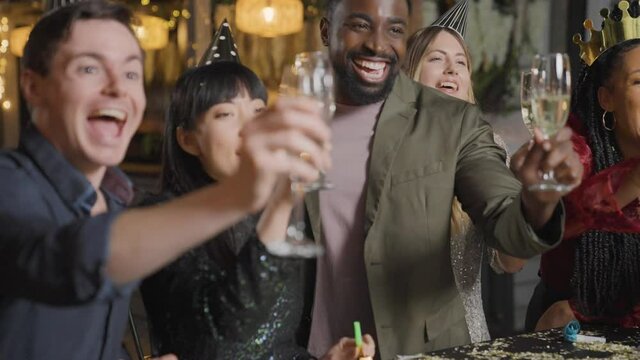 Tracking Shot of Friends Raising Their Glasses and Saying Happy New Year 