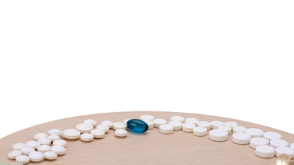 Assorted pharmaceutical medicine pills, tablets and capsules over blue background