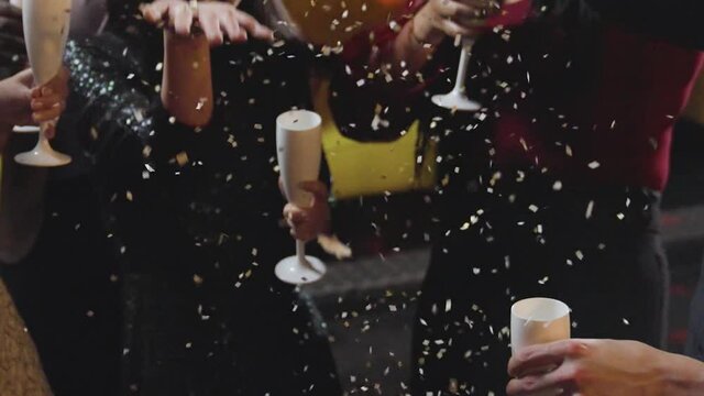 Close Up of Friends Celebrating New Years Eve with Confetti