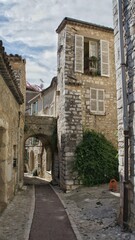 Fototapeta na wymiar Provence, France, September 2010, stone arch on a cobbled street in the ancient city of Saint-Paul-de-Vence