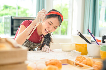 A young beautiful Asian woman is baking in her kitchen  , bakery and coffee shop business