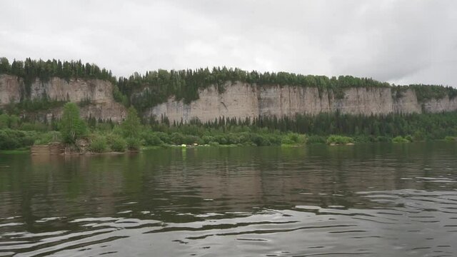Rest on the water. View of the rock from a catamaran sailing along the river. Russia