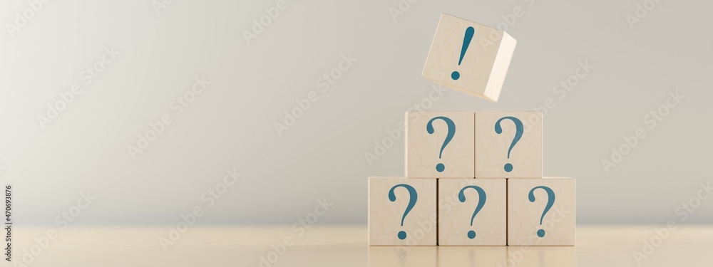 Poster pyramid of wooden blocks or cubes with question mark symbol icons stacked on wooden table with excla
