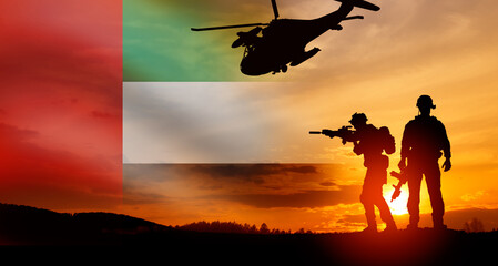 Silhouette of soliders against the flag of UAE. Concept of national holidays.