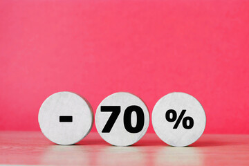Percent sign on wooden figure against red background with copy space. Concept of sale and discount.