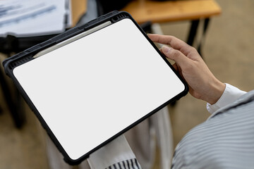 Blank screen of tablet, person holding tab and looking at blank tablet screen, mockup screen for further editing can be used for a variety of tasks. copy space.