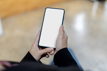 Smartphone blank screen, person holding smartphone and looking at blank screen, mockup screen for further editing can be used in a variety of tasks. copy space.