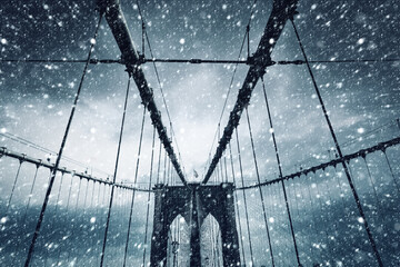 Brooklyn Bridge in winter during snowfall