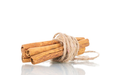 Several fragrant dry cinnamon sticks, close-up, isolated on white.