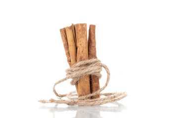 Several fragrant dry cinnamon sticks, close-up, isolated on white.