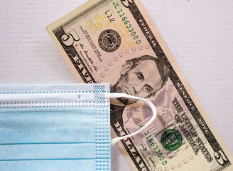 Mask and american dollars close up. Business and health