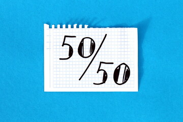  It says 50-50 on white squared notebook paper.