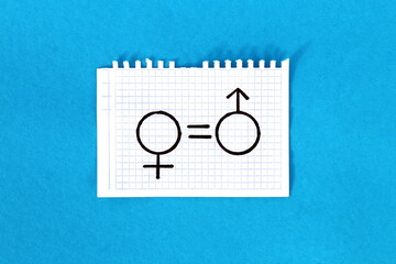 A gender equality sign is drawn on white paper.