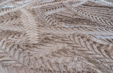 Photo of brown earth and sand with traces of construction equipment