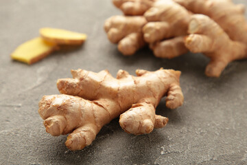 Fresh ginger with sliced on grey background
