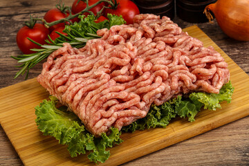 Raw pork minced meat over board