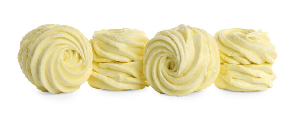 Many delicious yellow zephyrs on white background