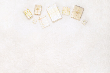 Christmas gifts boxes wrapping  in white gold paper for family lying on fluffy snow-white carpet. Copy space. Top view