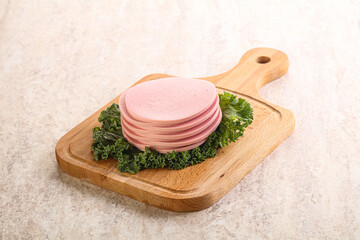 Slices pork sausage over board