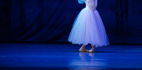 Closeup of ballerina dancing isolated on stage.