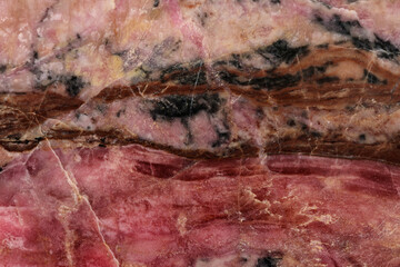 Macro stone Rhodonite mineral on a black background