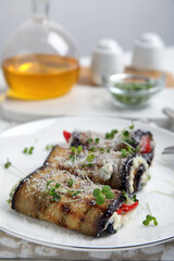 Delicious baked eggplant rolls served on table, closeup