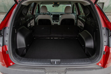 Huge, clean and empty car trunk in interior of compact suv. Rear view of a SUV car with open trunk