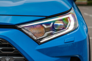 Headlight lamp of new cars. Close up detail on one of the LED headlights modern car. Exterior closeup detail. Closeup headlights of car.