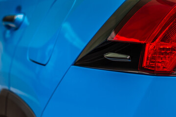 Modern rear light of a car. Brake light and arrow of large suv. Rear light of car close up view. Tail light.