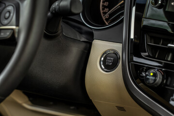 Fototapeta na wymiar Close up engine car start stop button. Modern car interior details.