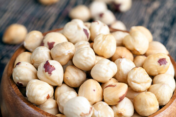 peeled and roasted hazelnuts on a wooden table