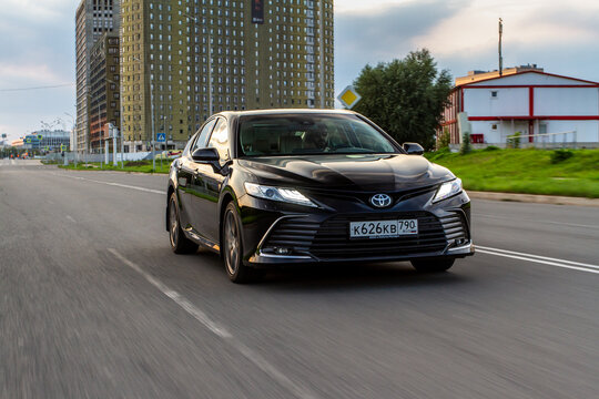 MOSCOW, RUSSIA - AUGUST 15, 2021 Toyota Camry (XV70), a mid-size sedan car model year 2021 on city background. Toyota Camry in motion view.