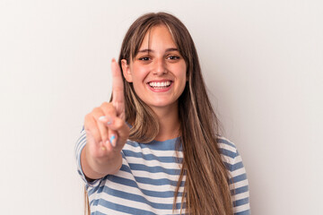 Young caucasian woman isolated on white background showing number one with finger.